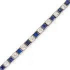 AN ART DECO SAPPHIRE AND DIAMOND LINE BRACELET comprising a row of alternating square step cut