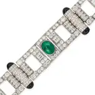 A FINE ART DECO EMERALD, DIAMOND AND ONYX STRAP BRACELET comprising a row of geometric motifs with