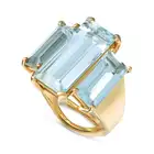 A VINTAGE AQUAMARINE THREE STONE RING in yellow gold, set with three elongated octagonal step cut