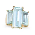 A VINTAGE AQUAMARINE THREE STONE RING in yellow gold, set with three elongated octagonal step cut