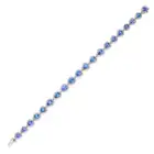 A CEYLON SAPPHIRE AND DIAMOND BRACELET set with a row of pear cut sapphires in borders of round
