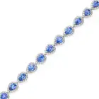 A CEYLON SAPPHIRE AND DIAMOND BRACELET set with a row of pear cut sapphires in borders of round