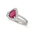 A BURMESE RUBY AND DIAMOND RING set with a pear cut ruby of 1.68 carats in a halo of round brilliant