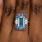 A FINE AQUAMARINE, SAPPHIRE AND DIAMOND DRESS RING set with an octagonal step cut aquamarine of