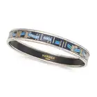 NO RESERVE - HERMES, AN ENAMEL BANGLE the bangle designed with a scrolling blue Hemres Paris ribbon,