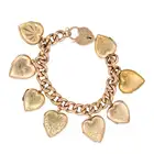 AN ANTIQUE GOLD HEART LOCKET CHARM BRACELET in yellow and rose gold, comprising a curb chain