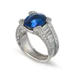 A FINE THAI SAPPHIRE AND DIAMOND DRESS RING in 18ct white gold, set with an oval cut sapphire of 7.