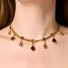 ALFRED PHILIPS, A FINE ANTIQUE IMPERIAL TOPAZ AND GARNET NECKLACE in yellow gold, comprising a row