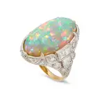 A VINTAGE OPAL AND DIAMOND DRESS RING set with an oval cabochon opal of approximately 11.34