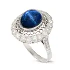 A STAR SAPPHIRE AND DIAMOND DRESS RING the openwork ring set with an oval cabochon star sapphire