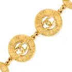 CHANEL, A SUNBURST BRACELET comprising four textured circular gold tone metal links with an