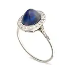 A FINE ANTIQUE SAPPHIRE AND DIAMOND DRESS RING, EARLY 20TH CENTURY set with an oval cabochon