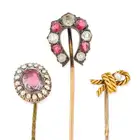 NO RESERVE - A COLLECTION OF FOUR ANTIQUE STICK PINS comprising a paste horse shoe stick pin 1.