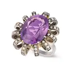 AN AMETHYST AND DIAMOND DRESS RING set with an oval cut amethyst of approximately 12.85 carats,