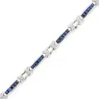 A SAPPHIRE AND DIAMOND BRACELET comprising links set with square step cut sapphires, accented by