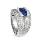 A SAPPHIRE AND DIAMOND DRESS RING set with an oval cut sapphire of approximately 2.57 carats,