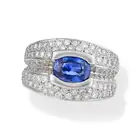 A SAPPHIRE AND DIAMOND DRESS RING set with an oval cut sapphire of approximately 2.57 carats,
