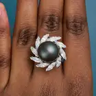 GRIMA, A VINTAGE NATURAL SALTWATER PEARL AND DIAMOND DRESS RING in platinum, set with a black