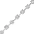 A DIAMOND BRACELET comprising a row of links set with cushion cut diamonds in borders of round