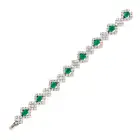 A FINE EMERALD AND DIAMOND BRACELET comprising a row of alternating octagonal step cut emeralds