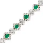 A FINE EMERALD AND DIAMOND BRACELET comprising a row of alternating octagonal step cut emeralds
