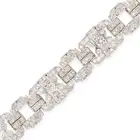 A FINE ART DECO DIAMOND STRAP BRACELET comprising a row of pierced geometric links, set throughout