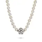 MIKIMOTO, AN AKOYA PEARL AND DIAMOND NECKLACE comprising a single row of pearls, the clasp set
