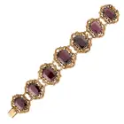 AN ANTIQUE GARNET BRACELET in yellow gold, the articulated body set with a row of graduated