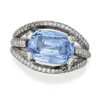 A 7.12 CARAT CEYLON NO HEAT SAPPHIRE AND DIAMOND RING set with a cushion cut sapphire of 7.12