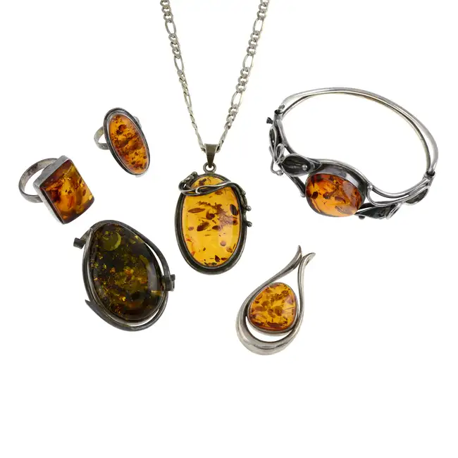 Six itmes of modified amber jewellery