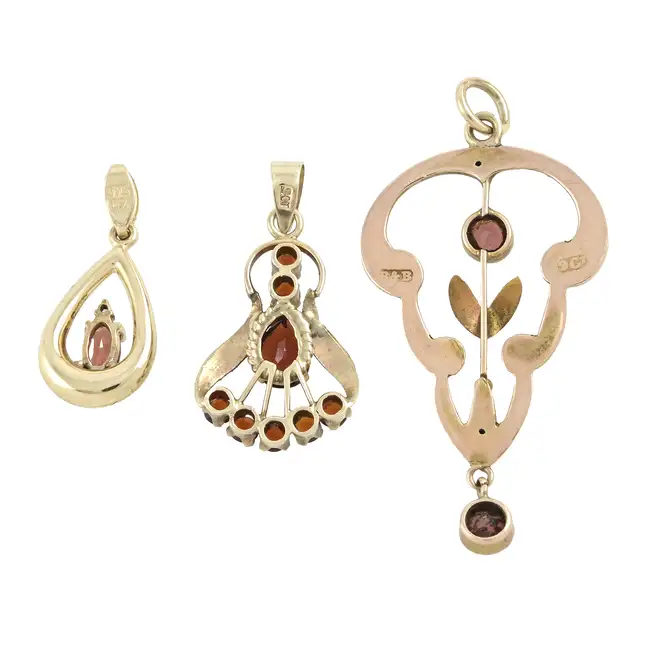 Three garnet pendants