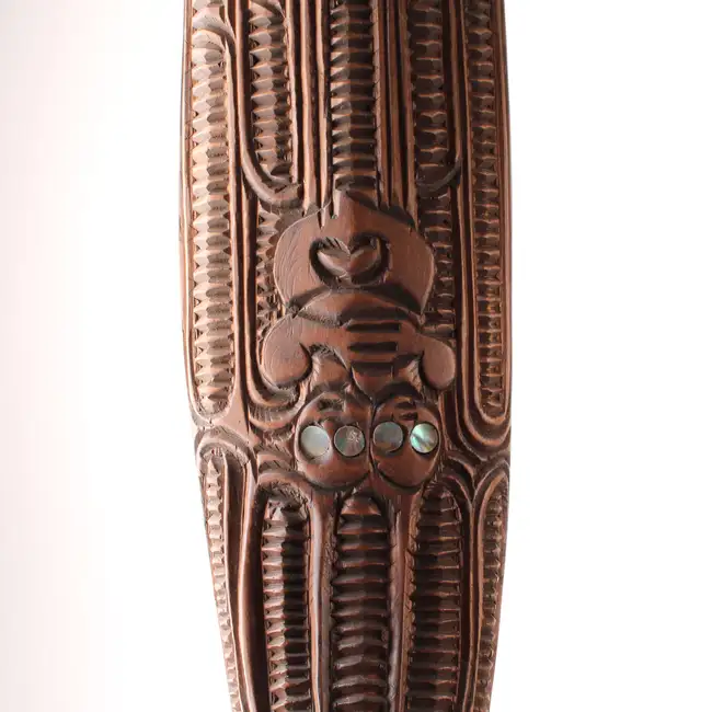 An African bust and a modern hardwood paddle