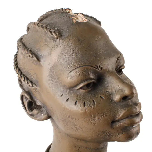 An African bust and a modern hardwood paddle