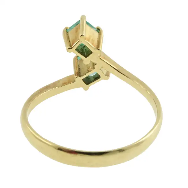 Emerald two-stone crossover dress ring