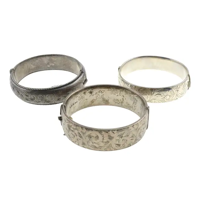 Three mid 20th century silver hinged bangles