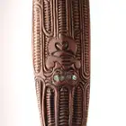 An African bust and a modern hardwood paddle