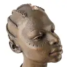 An African bust and a modern hardwood paddle