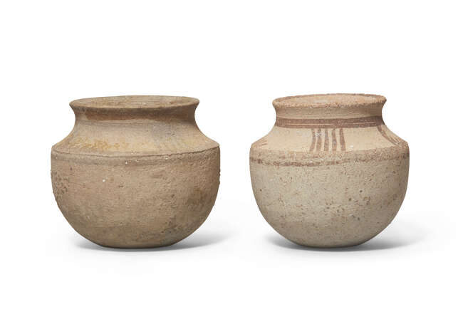 Two Iranian small buff pottery vessels with carinated shoulder and everted rim, the shoulder...