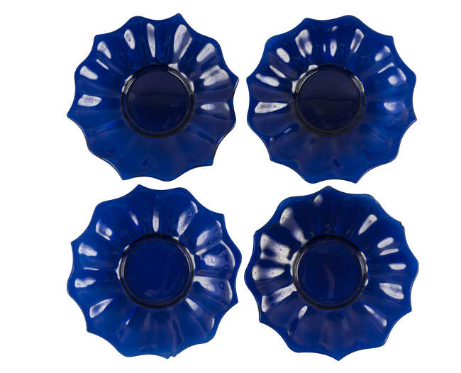 
	
		Four Chinese Peking blue glass &#39;lotus&#39; dishes, late 19th century, each moulded as a lotus...