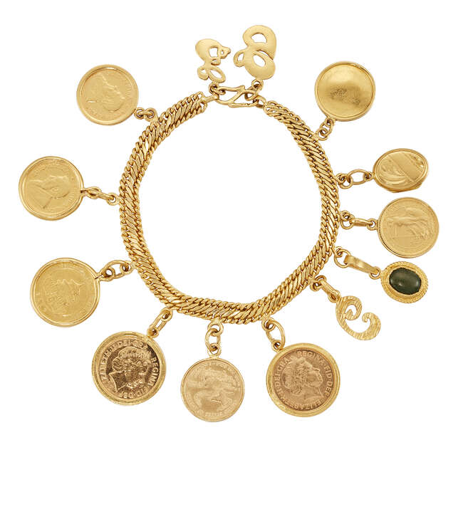 
	
		A gold coin bracelet with various charms, the 22ct. gold fancy curb-link bracelet...