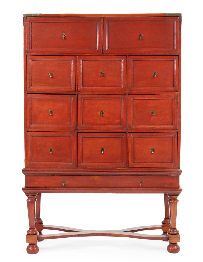 A Chinese red-lacquered two-part cabinet, late 18th / 19th century, with an arrangement of...