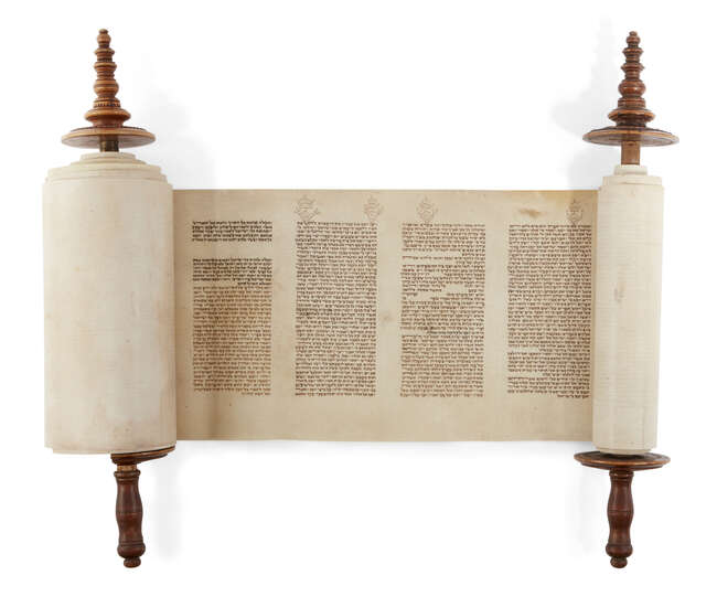
	
		A miniature 18th century Sefer Torah scroll mounted on carved wooden rollers, possibly...