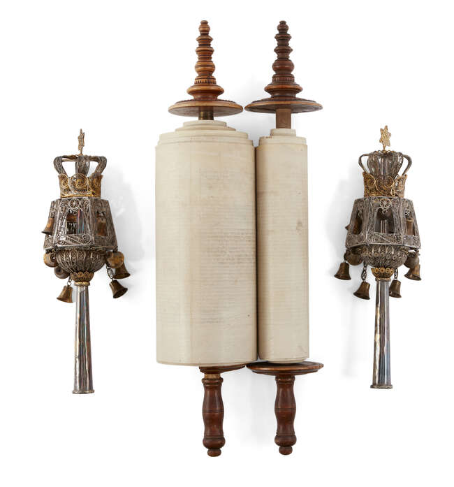 
	
		A miniature 18th century Sefer Torah scroll mounted on carved wooden rollers, possibly...