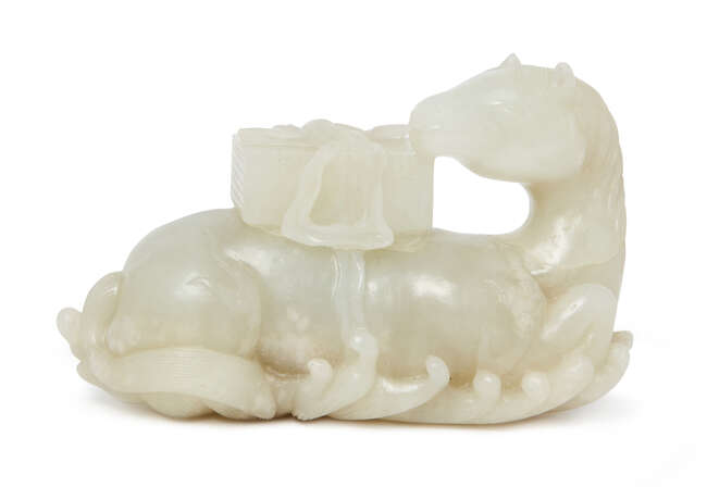 
	
		A fine Chinese white jade carving of a horse, 18th century, carved in recumbent pose on...