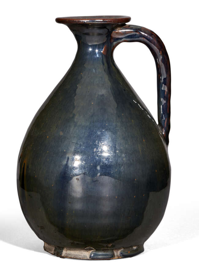
	
		A Chinese stoneware black-glazed ewer, Yuan dynasty, the pear-shaped body with loop...