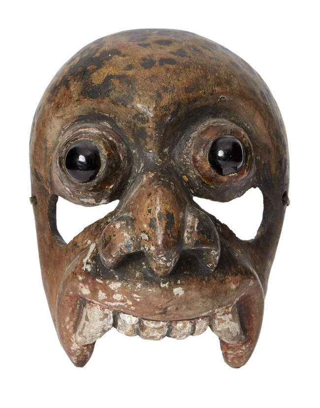 
	
		A wooden mask of demon Aturu Yaka, Ceylon (Sri Lanka), circa 1900, with black glass...