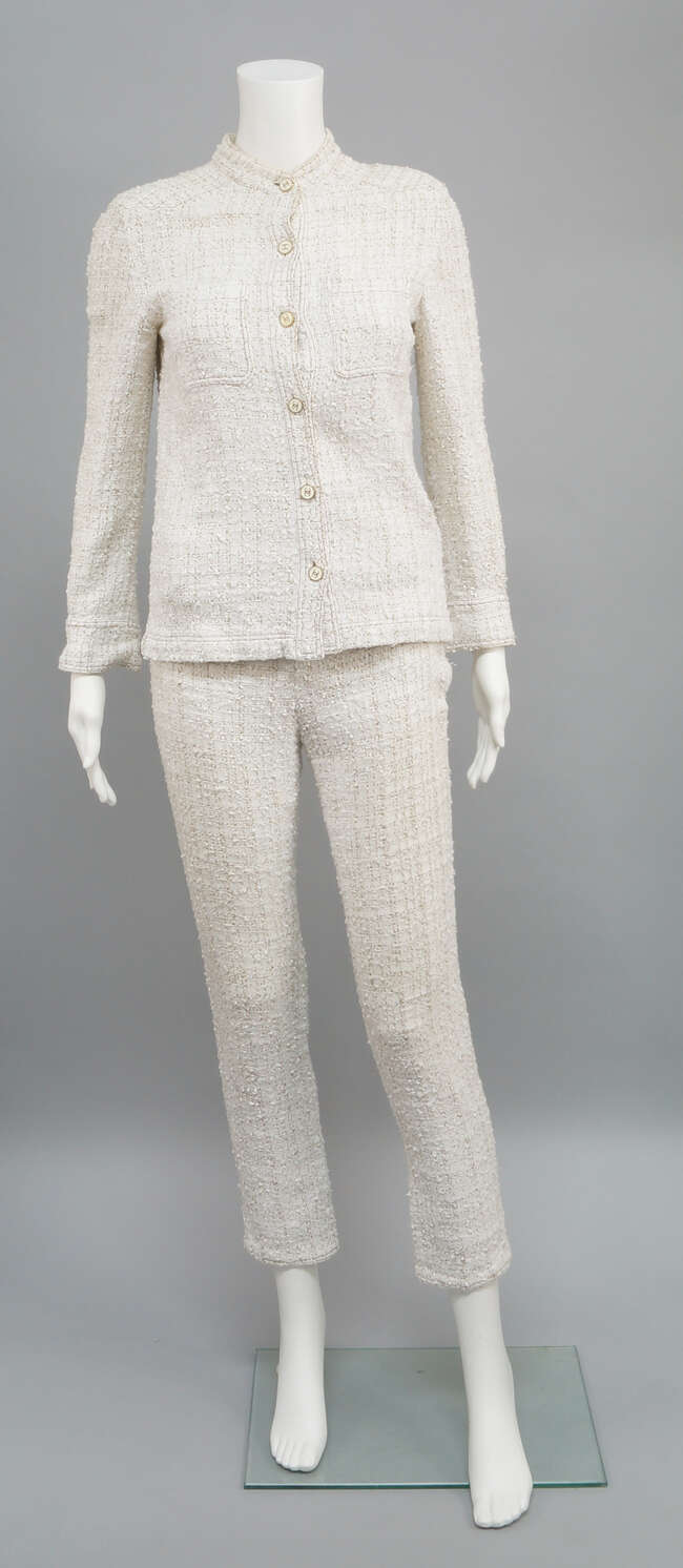 
	
		Chanel: a trouser suit, ivory cotton/rayon boucle with brown fleck, the collarless jacket...