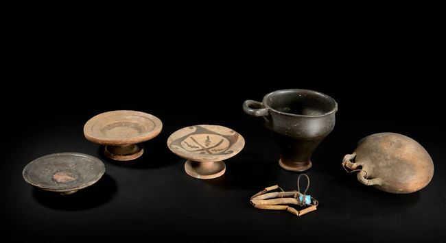 Four ancient pottery vessels, circa 4th Century B.C., including an Apulian black-glazed skyphos...