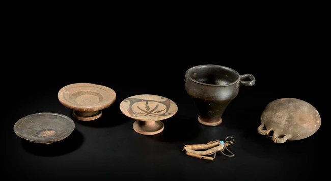 Four ancient pottery vessels, circa 4th Century B.C., including an Apulian black-glazed skyphos...
