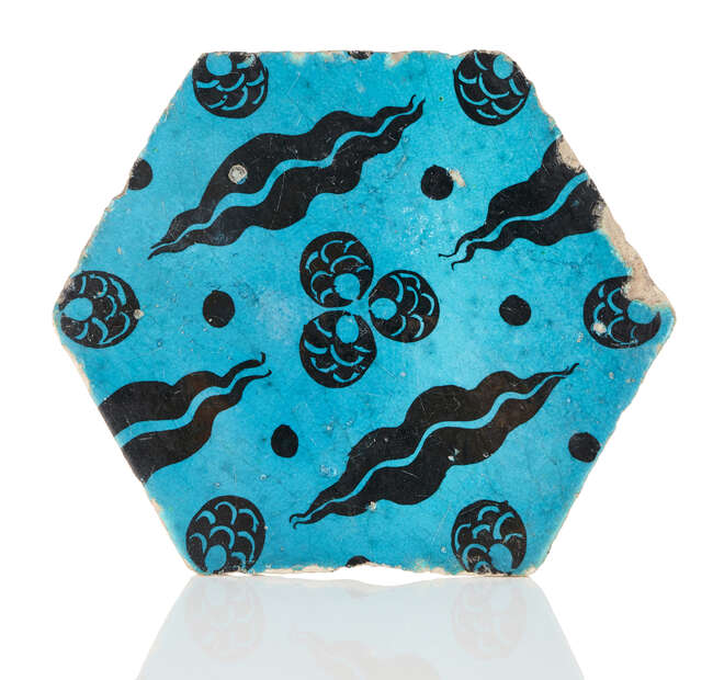 
	
		A hexagonal Cintimani tile, Ottoman Syria, 16th century, painted in black under a...